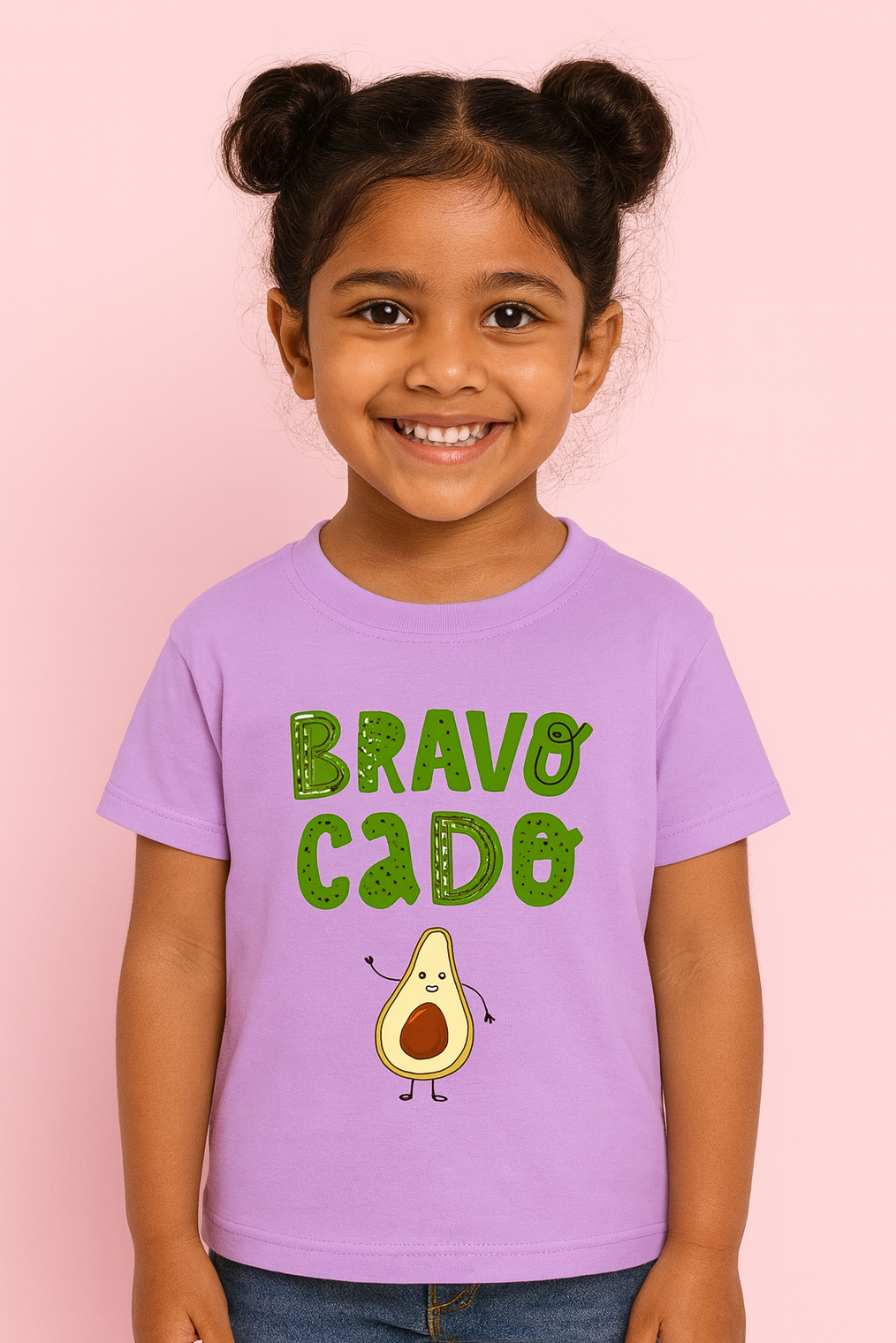 Child wearing a purple t-shirt with 'BRAVO CADE' and an avocado graphic on a pink background